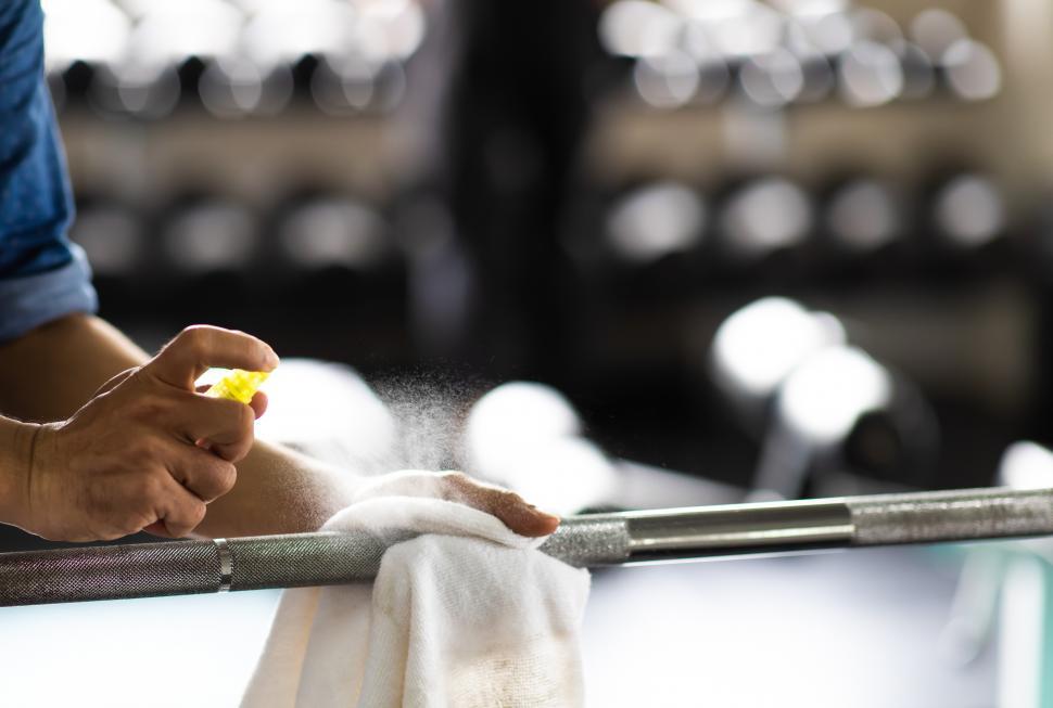 Free Image of Fitness staff cleaning exercise equipment 
