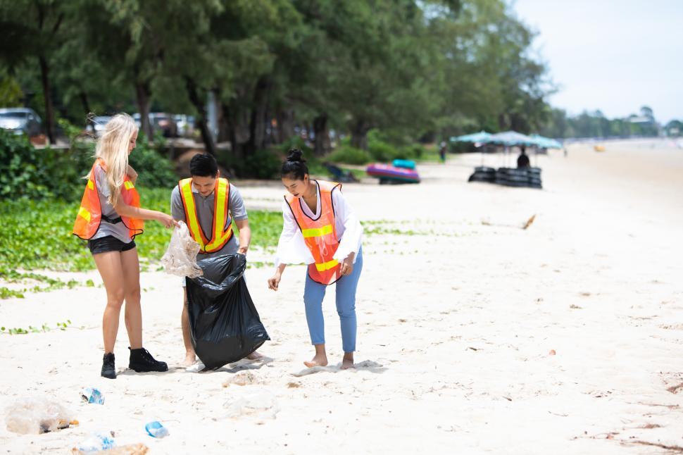Free Image of Group of diverse volunteers with garbage bags cleaning up 