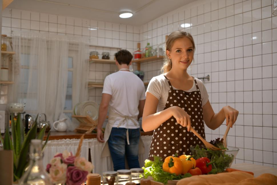 Free Image of Young woman cooking with her partner  