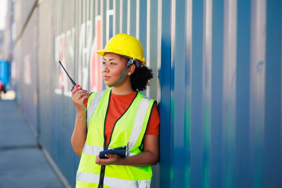 Free Image of Black woman controls loading containers 