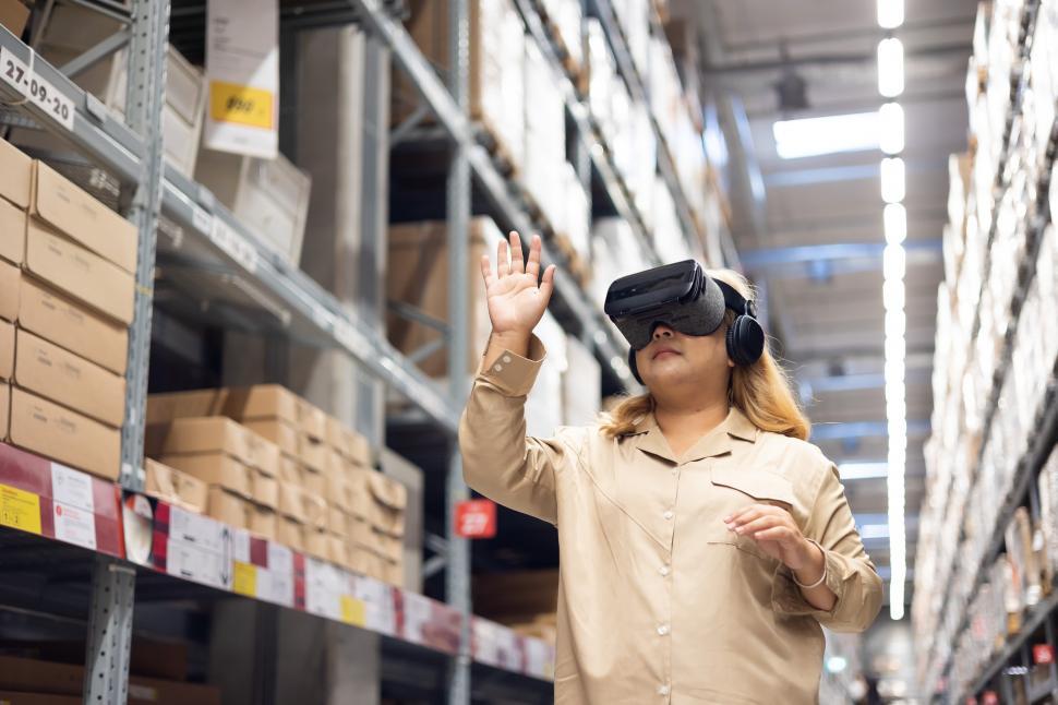 Free Image of Woman using VR headset in warehouse 