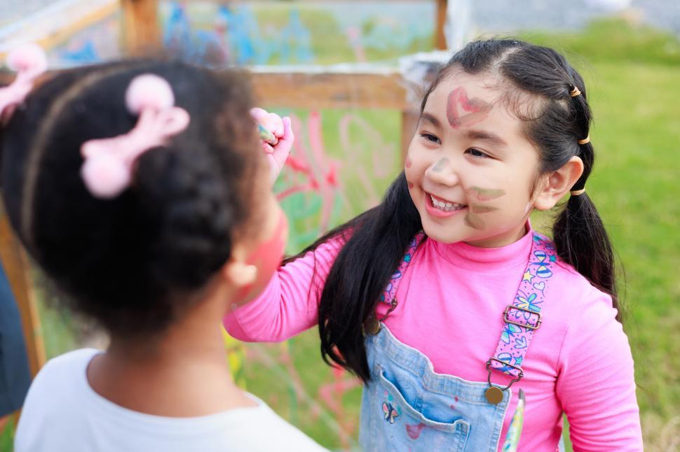 Free Image of Happy girl painting faces in the park 