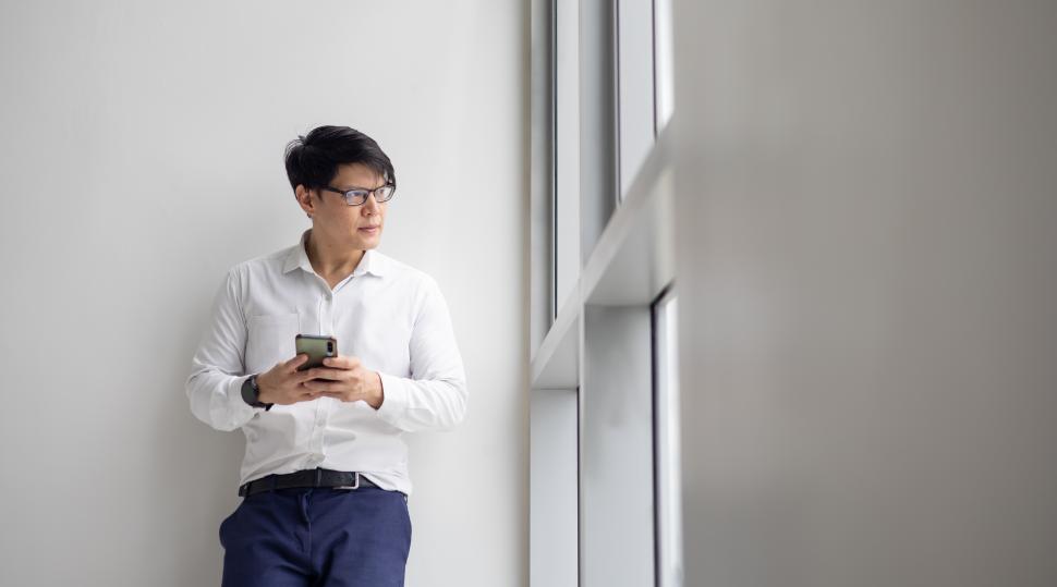 Free Image of Office worker holding mobile phone 