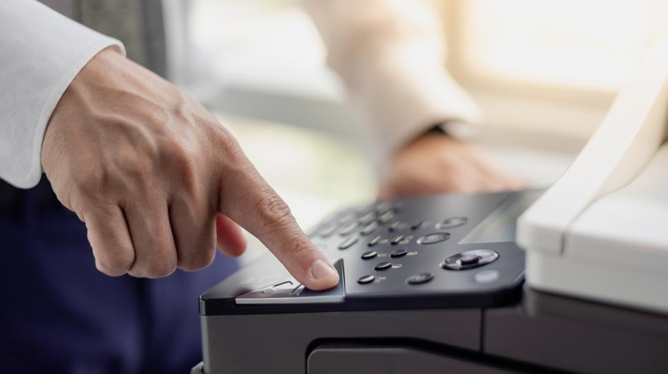 Free Image of Office worker using copy machine 