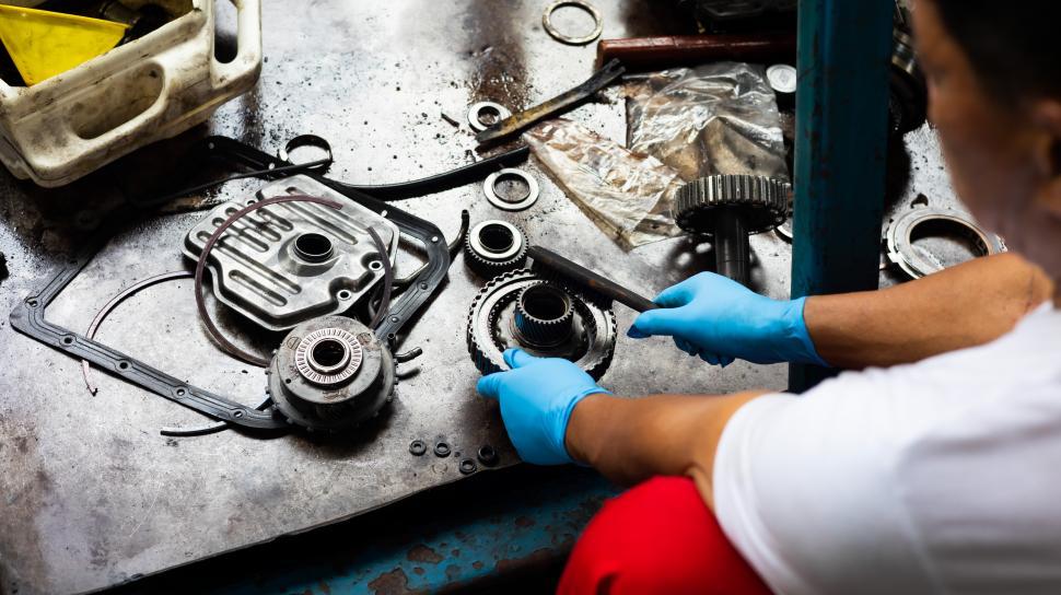 Free Image of Mechanic cleaning up car parts 
