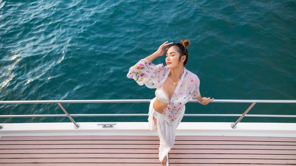 Free Image of Portrait Attractive Happy Asian female wearing swimwear on a boat 