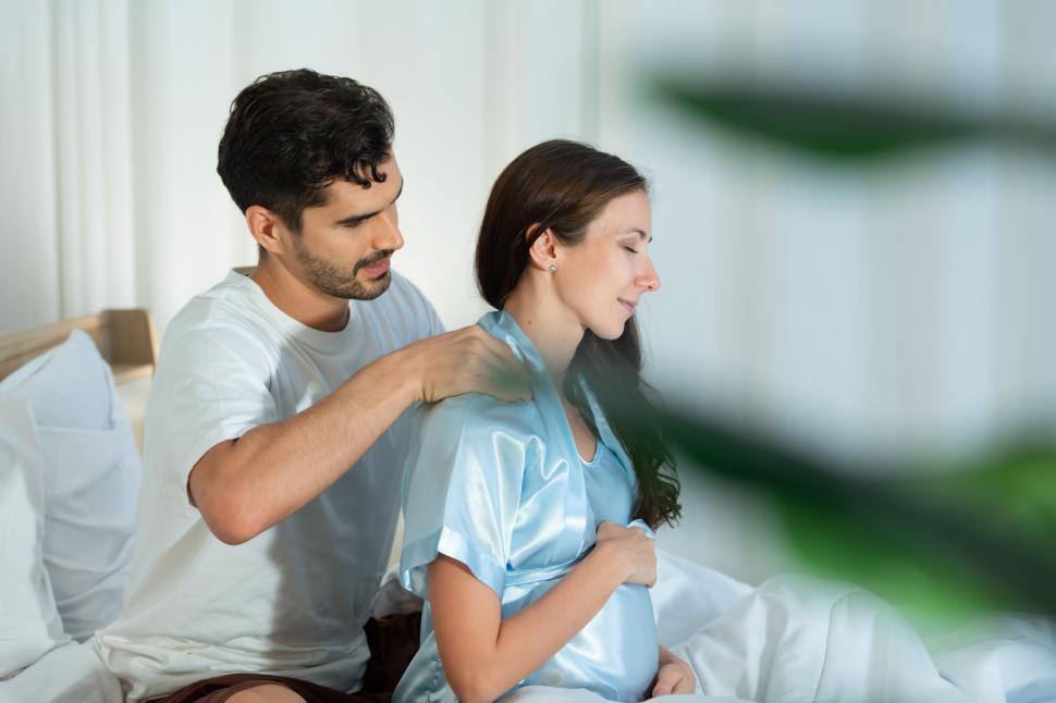 Free Image of Husband giving a pregnant wife a massage so that the wife can relax 