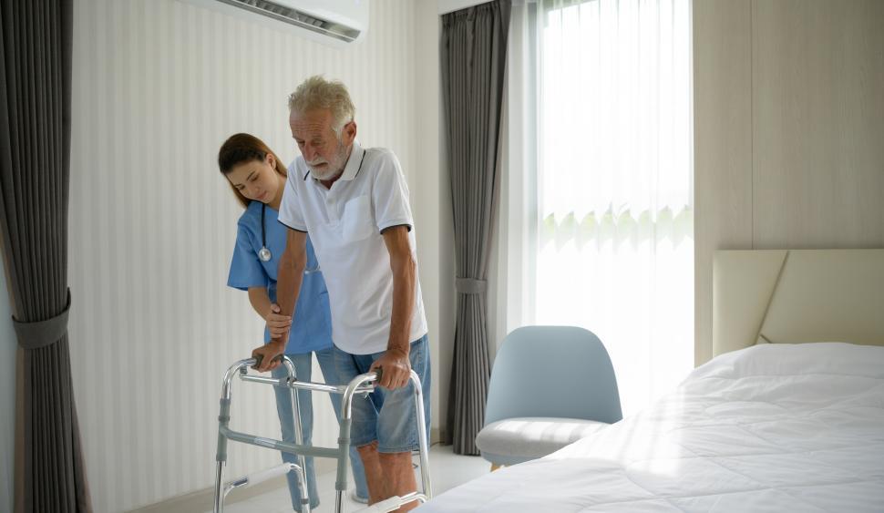 Free Image of Doctors help elderly patients with mobility and recovery 