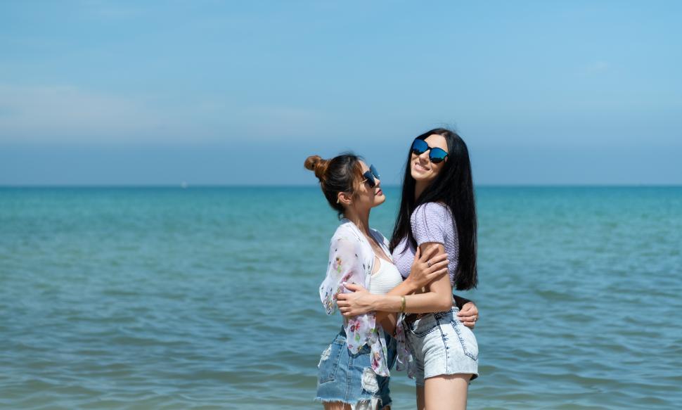 Free Image of LGBT couple traveling around Asia, Swim happily on the beach 