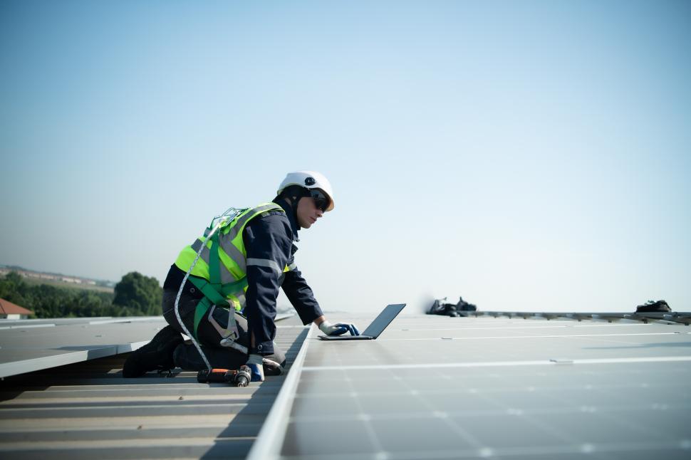 Free Image of Engineer working on solar panel installation, monitoring panel performance 