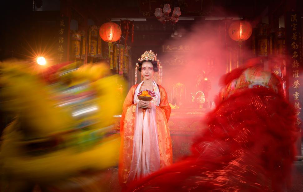 Free Image of Chinese woman with yellow and red lions during Chinese New Year celebration 