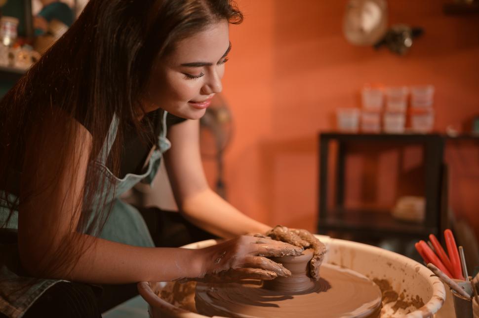 Free Image of Young female ceramic artist making a piece of pottery 