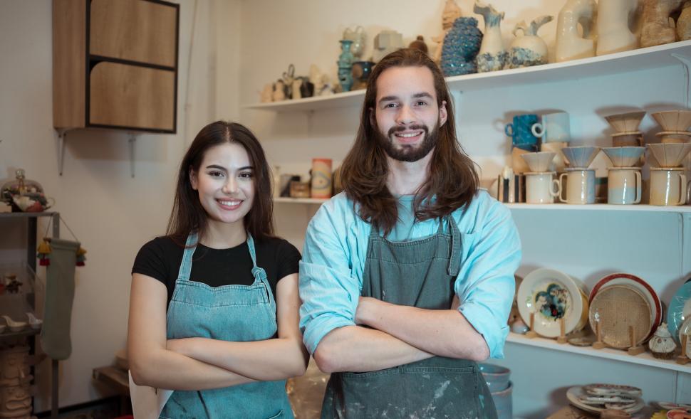 Free Image of Portrait of Young business man and woman, owners of a small gallery 