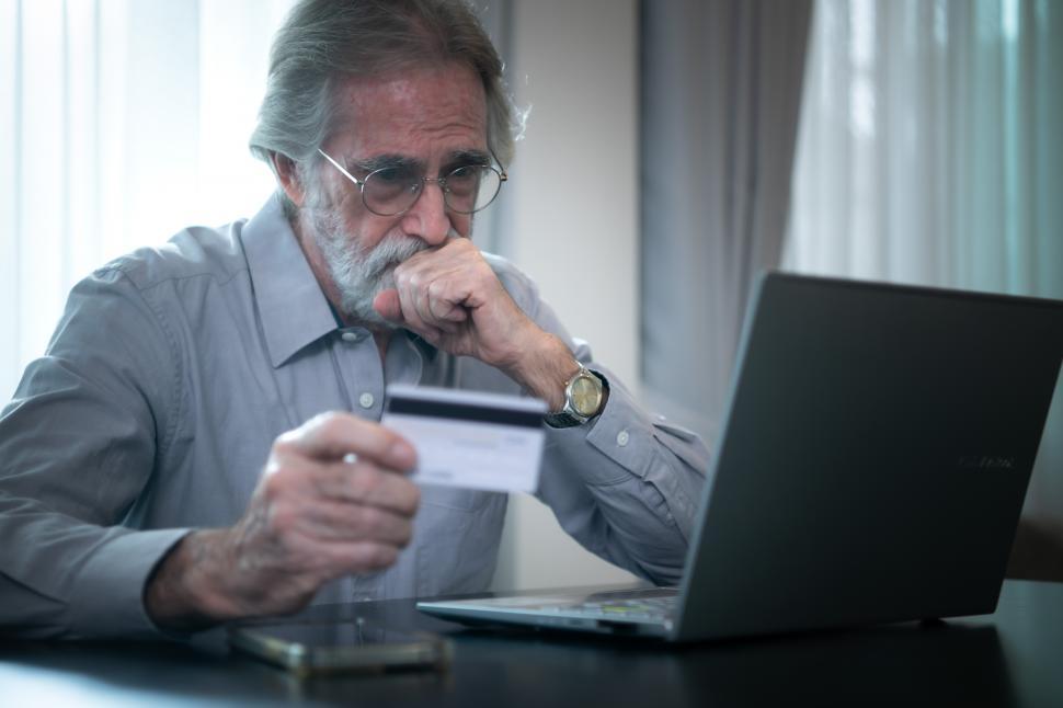 Free Image of An elderly man experiencing financial difficulties and credit card debt 