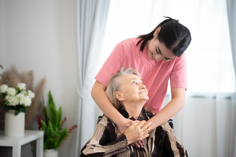 Free Image of Caregiver sharing a look with an elderly woman at weekly check in 