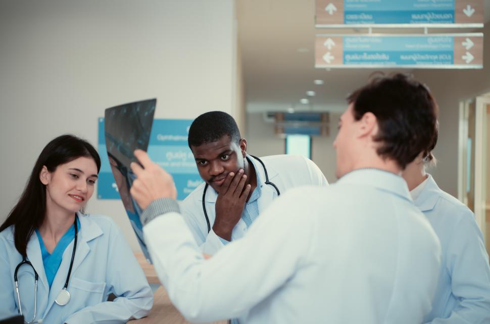 Free Image of Medical teacher and interns analyzing the x-ray results 