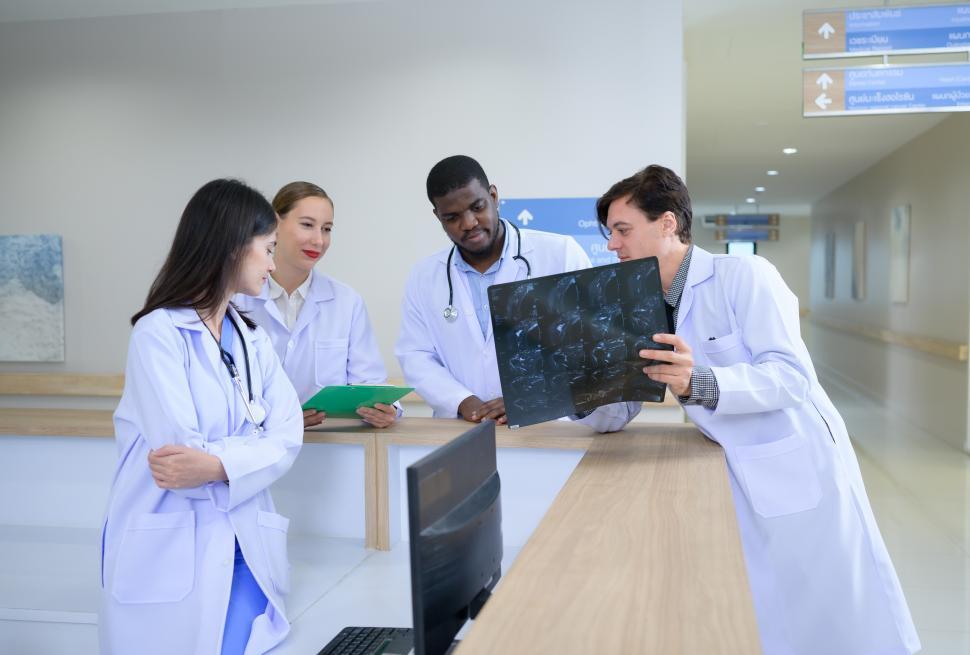 Free Image of Medical teacher and interns examine x-ray results 