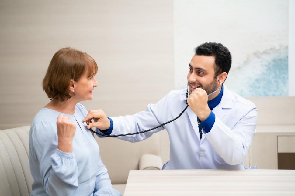 Free Image of Physician listening to heart beat of female patient in professional office 