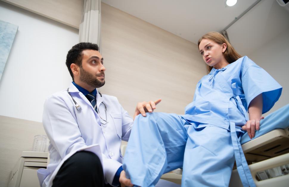 Free Image of Doctor doing physical examination of young female patient 