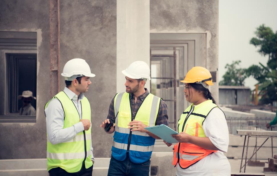 Free Image of Group of architects, construction foremen, and construction engineers on jobsite 