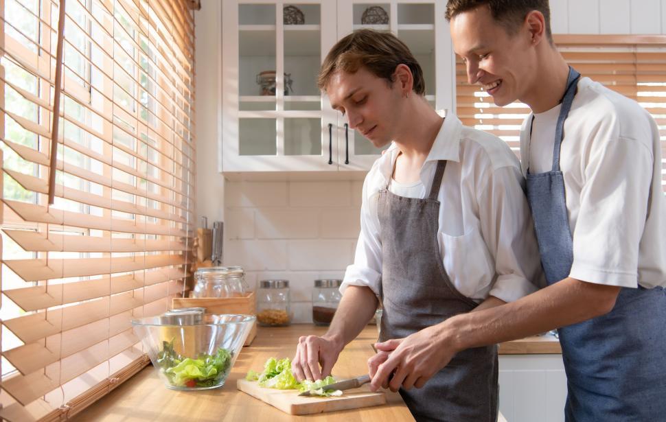 Free Image of LGBT young couple makingn food together in the kitchen 