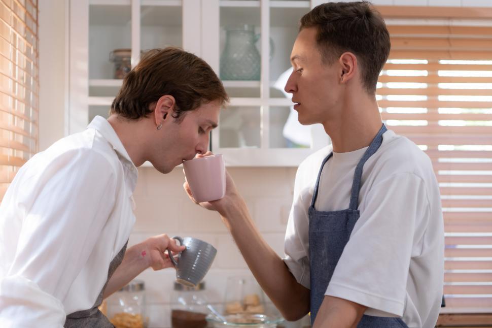 Free Image of Young LGBT couple taking a break for tea and coffee in the kitchen 