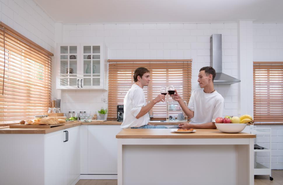 Free Image of Young LGBTQ couple celebrate the day of love between each other with a toast 