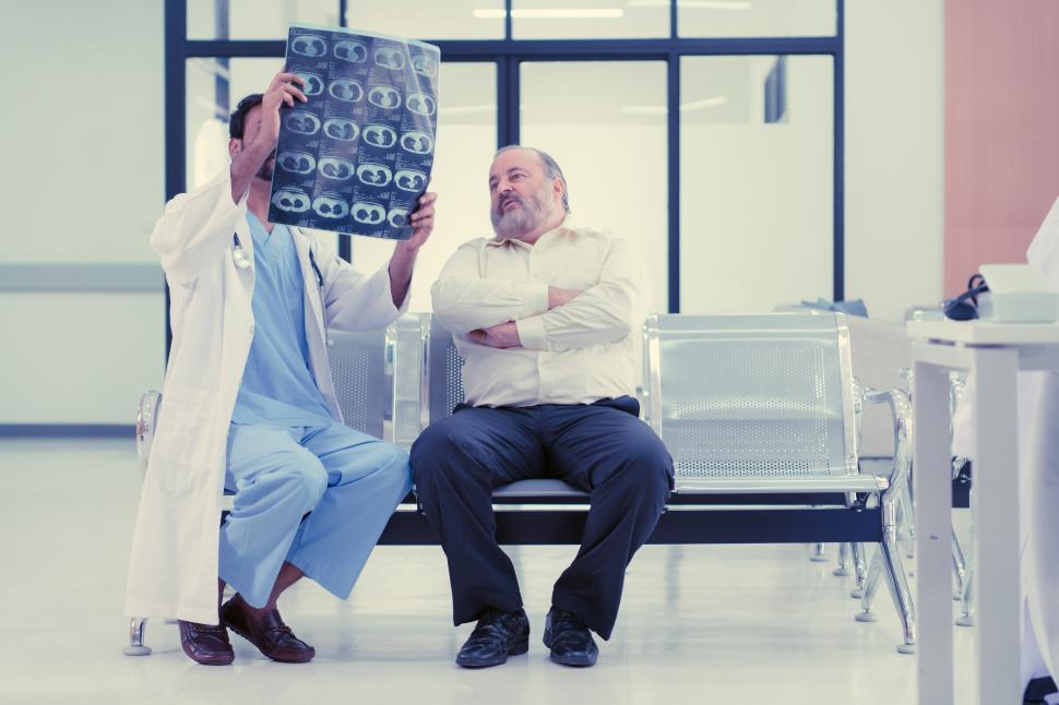 Free Image of The doctor talks to the patient about the results of imaging scans 