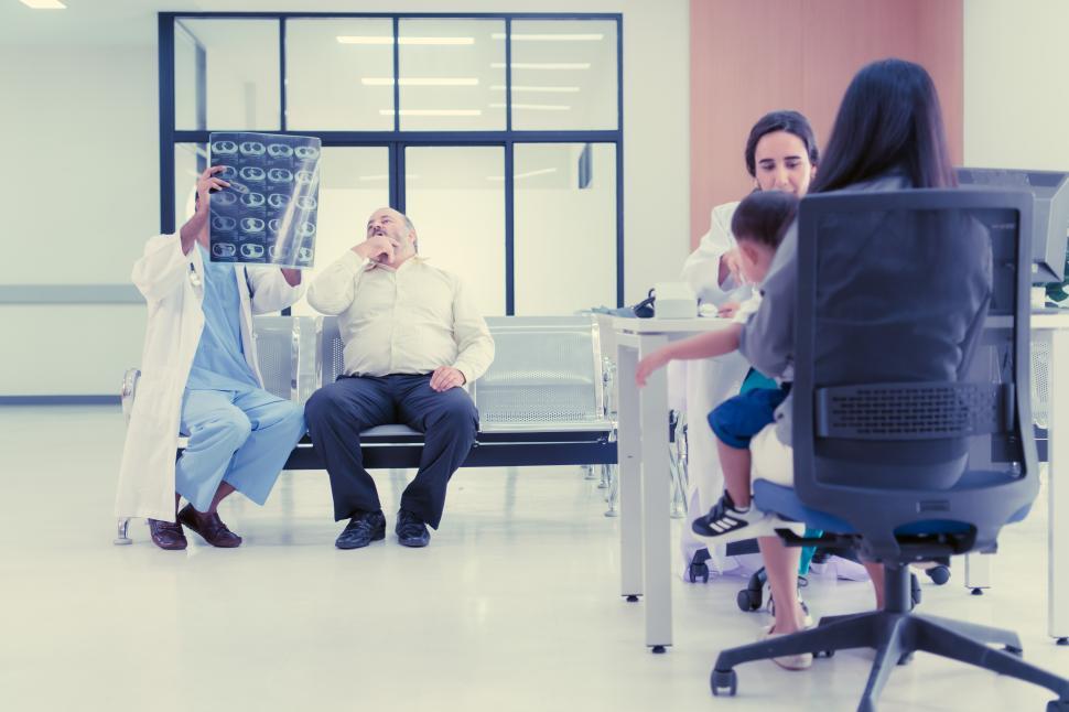 Free Image of The doctor talks to the parents of a patient about the results of a brain scan 