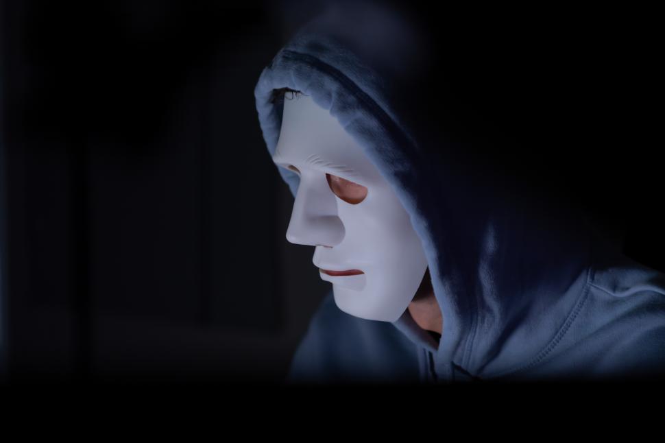 Free Image of This is the face of a masked hacker who is knowledgeable with malware 