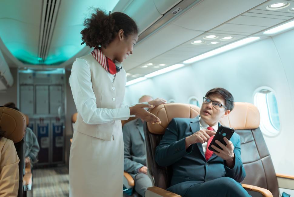 Free Image of Flight attendants give advice on safety when in the plane 