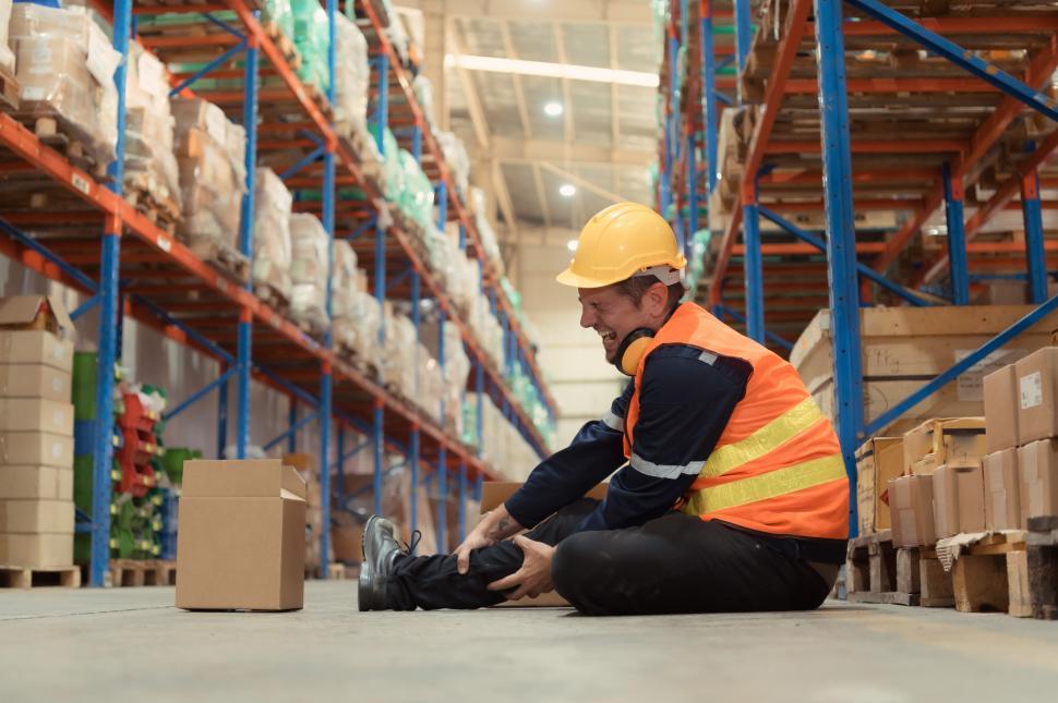 Free Image of A warehouse employee injured in an accident on the warehouse floor 