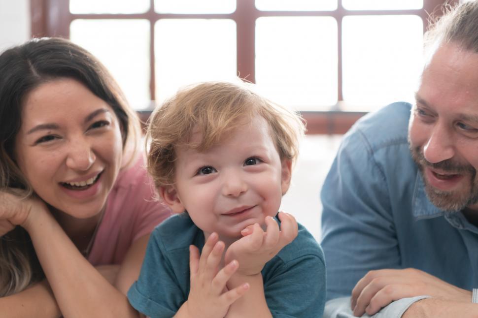 Free Image of Cute little boy with his family, facing the camera 