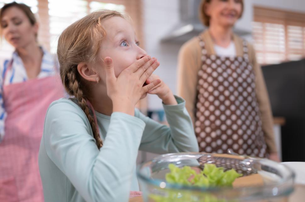 Free Image of Amazed daughter or granddaughter in a kitchen with plenty of natural light 
