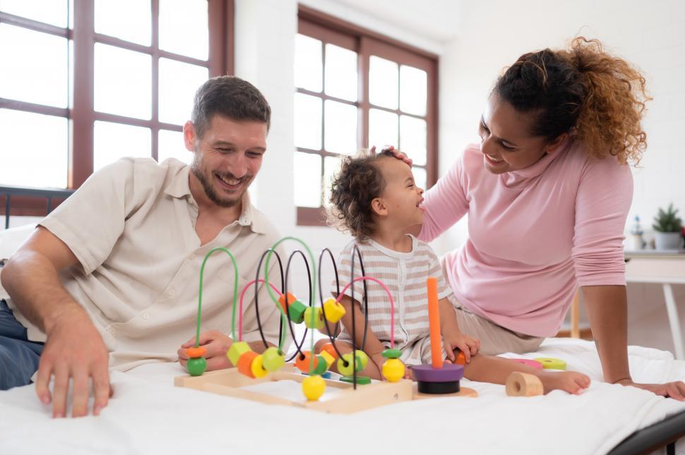Free Image of Parents with little kid have fun playing with new toys together 