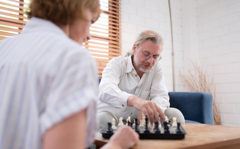 Free Image of Elderly couple playing a game of chess together 