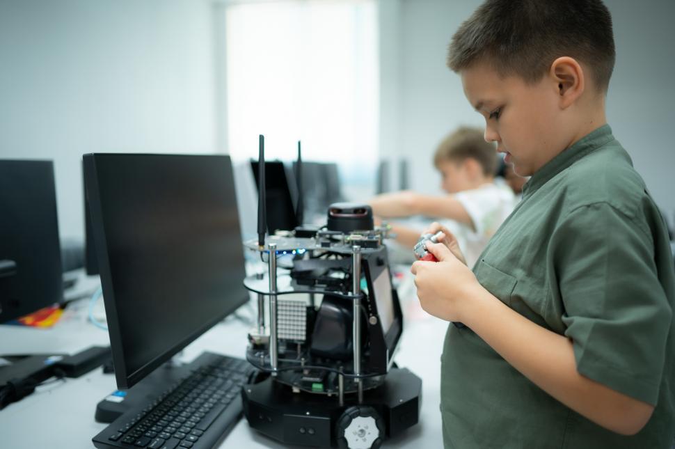 Free Image of Young kid learning about robotics in a computer lab 