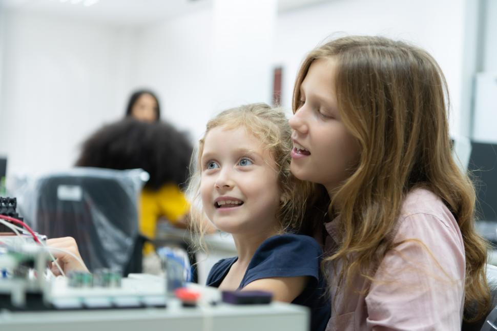 Free Image of Two girls learning in a STEM electronics laboratory to do hands on work 