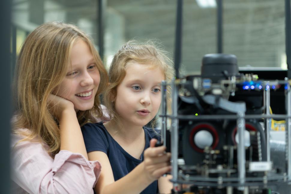 Free Image of Two girls working with a machine in a STEM robotics lab 