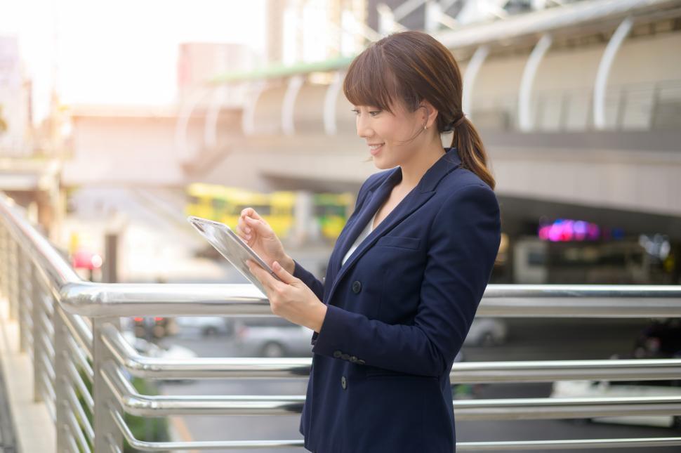 Free Image of beautiful young businesswoman is using tablet in modern city 