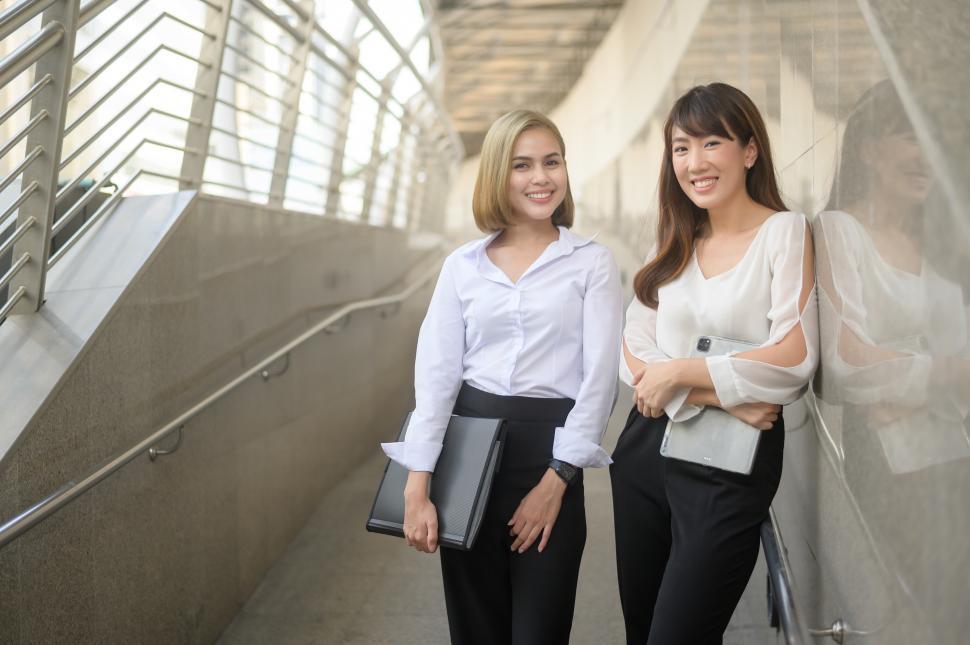 Free Image of Two young professional women standing together in a modern building 