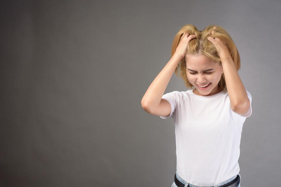 Free Image of portrait of woman stressed and depressed grabbing her hair 