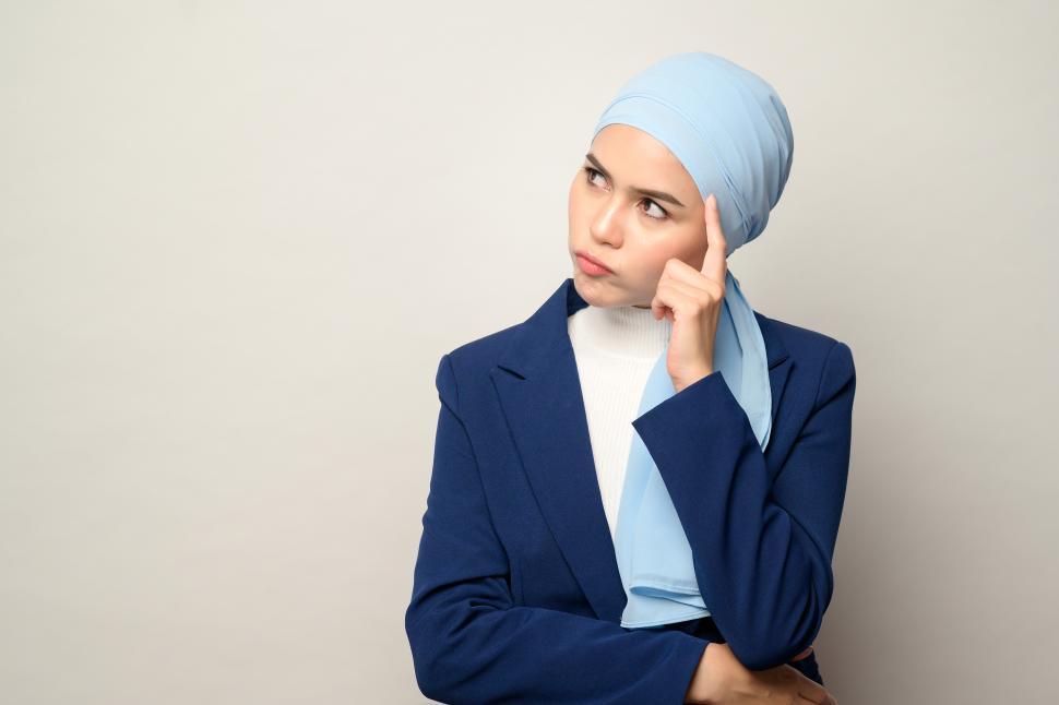 Free Image of Muslim businesswoman with hijab thinking intensely 