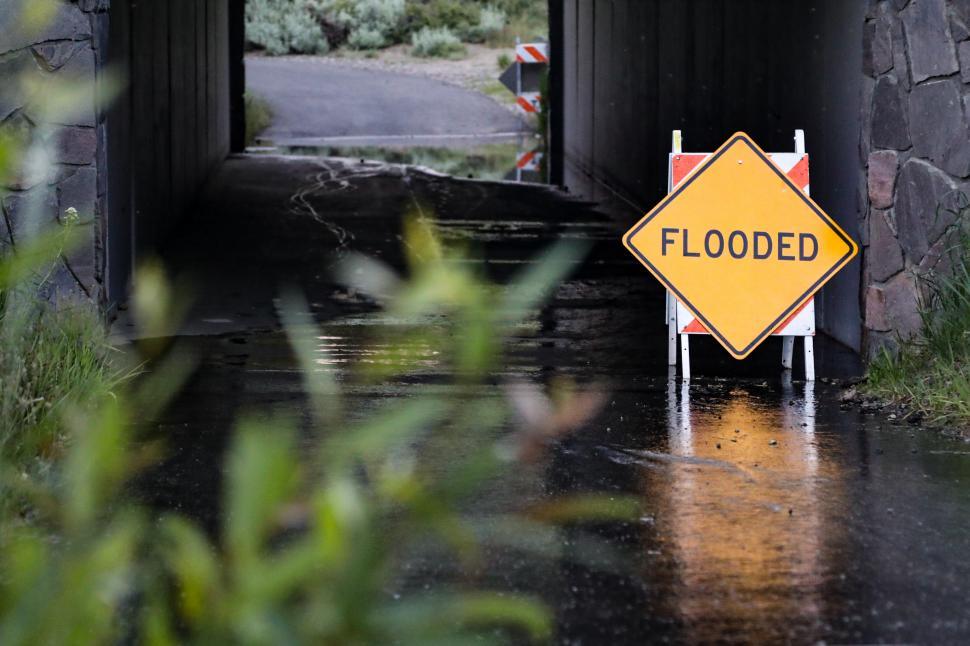 Free Image of Sign shows that underpass is flooded 