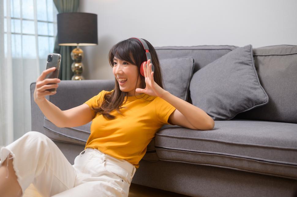 Free Image of Young happy woman listening to music and relaxing at home 