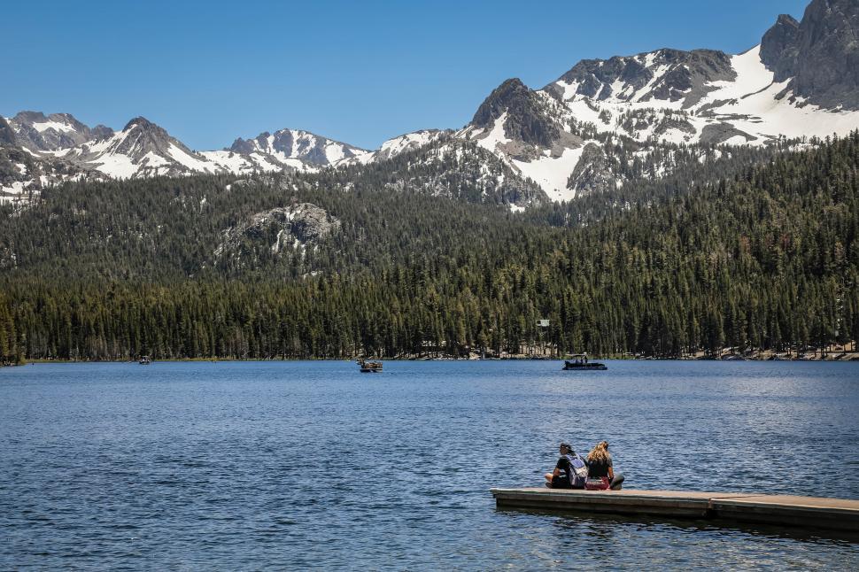 Free Image of People sitting on a pier, admiring Lake Mary in the Mammoth Lakes Basin, California 