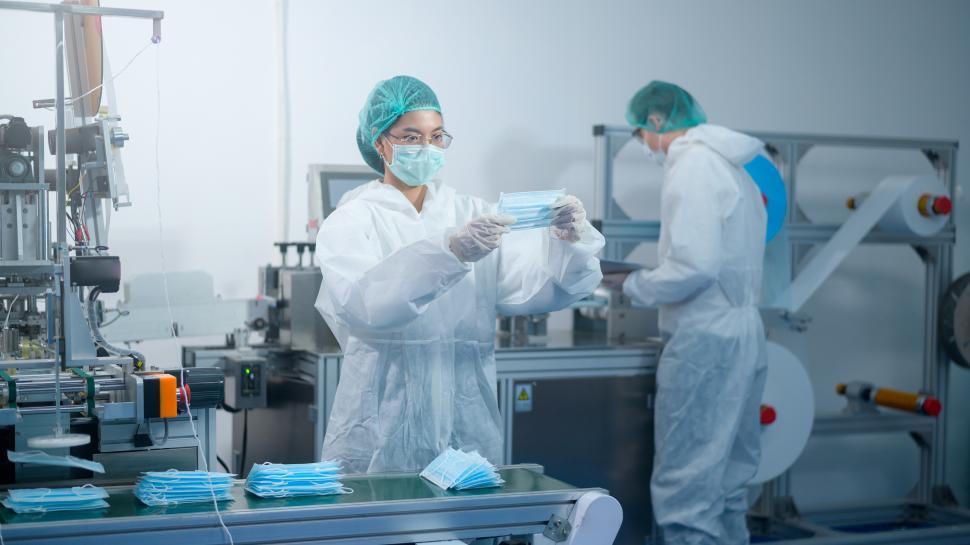 Free Image of Workers producing surgical masks in modern factory, Personal protective equipment production 