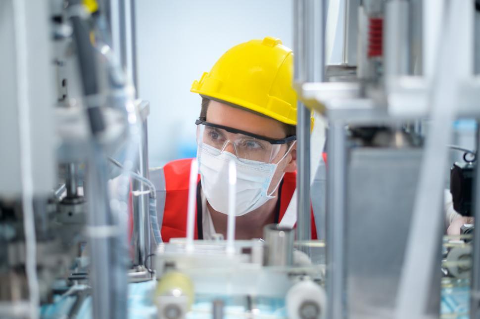 Free Image of Quality control QC engineer monitoring and checking machine 