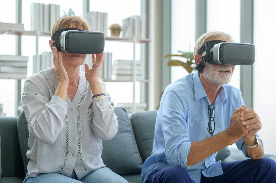 Free Image of Senior citizen couple wearing vr headsets at home 