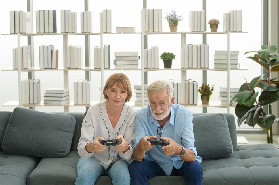 Free Image of Happy Caucasian senior couple playing video games at home 